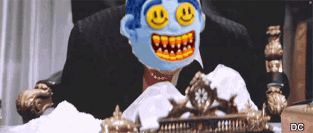 a cartoon character with a smiley face on his face is sitting at a table