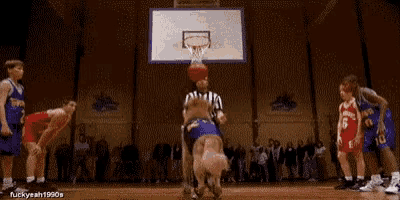 a group of basketball players are playing a game of basketball with a referee .