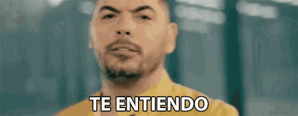 a man in a yellow shirt is making a funny face and saying te entiendo .