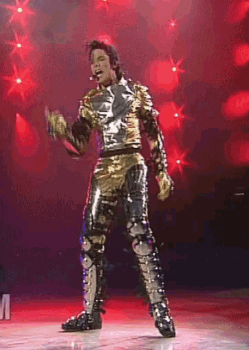 a man in a gold and black outfit is on a stage