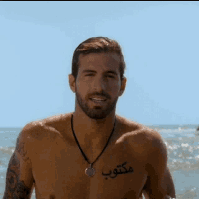 a shirtless man with a tattoo on his chest that says ' ' on it