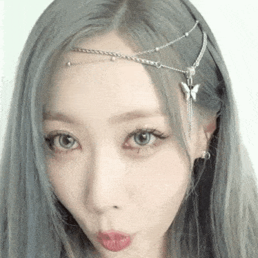 a close up of a woman wearing a headband with a butterfly