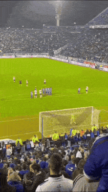 a soccer game is being played in a stadium with a lot of people