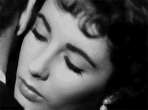 a close up of a woman 's face with her eyes closed .