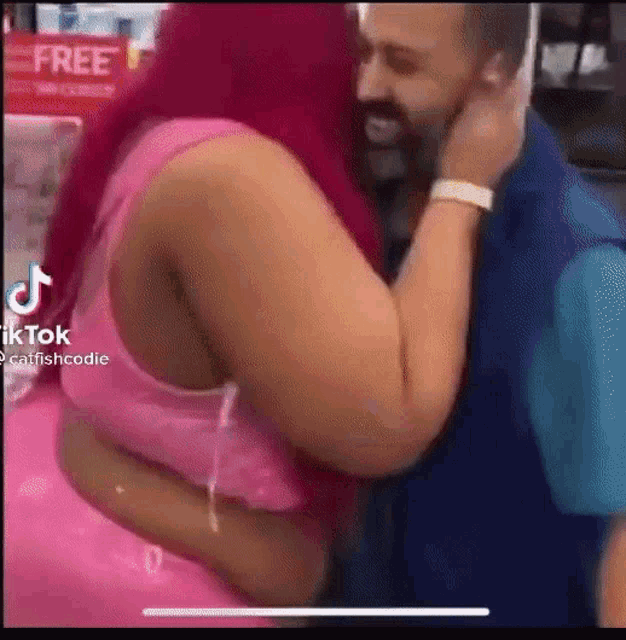a man and a woman are hugging each other in a store .