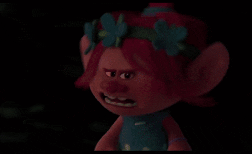 a cartoon character with a purple face is looking at a mouse