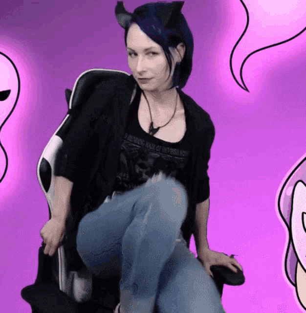 a woman with blue hair is sitting in a chair wearing a shirt that says " i meant to make it easy for you "