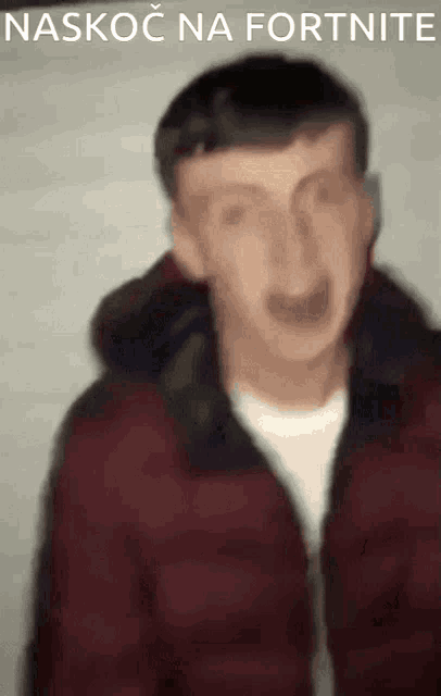 a blurry picture of a man with the words naskoc na fortnite written on the bottom