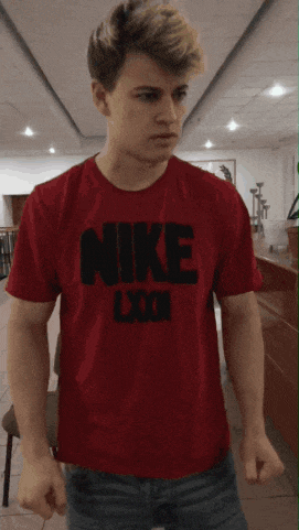 a young man wearing a red nike t shirt