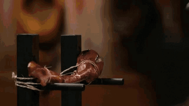 a piece of meat is being smashed by a sword