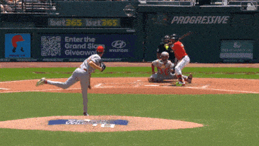 a baseball game is being played in front of an advertisement for bet365