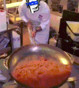 a chef is stirring a pan of sauce with a smiley face drawn on his head