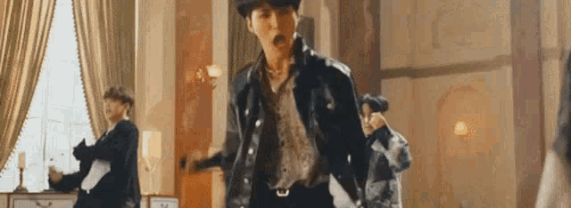 a group of men are dancing in a room in a room .