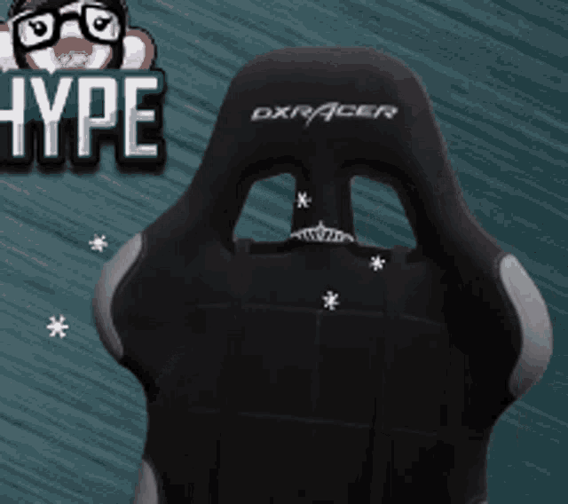 a black dxracer gaming chair is sitting in front of a blue background