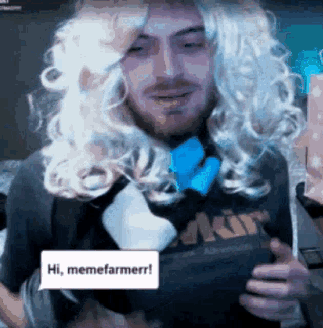 a man wearing a wig and a memefarmerr shirt