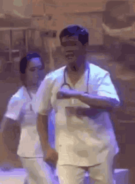 a man with a stethoscope around his neck is dancing with another man