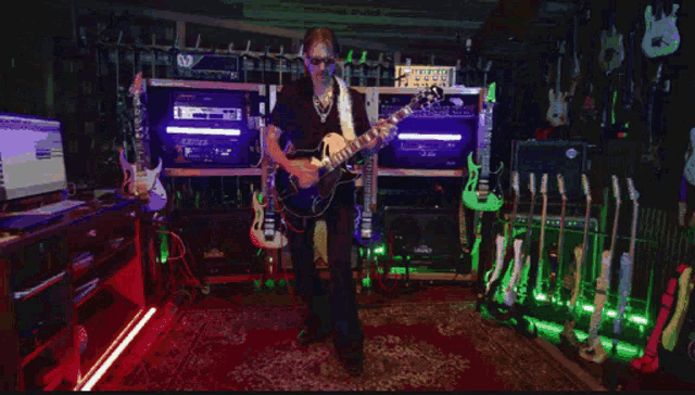 a man wearing sunglasses plays a guitar in a dark room