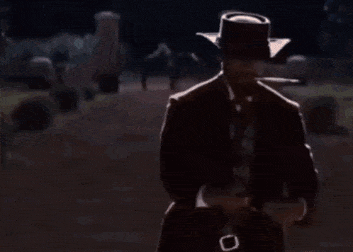 a man in a cowboy hat is smoking a cigarette
