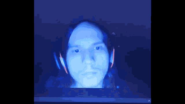 a man 's face is displayed on a samsung computer screen