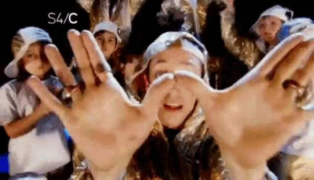 a group of young people are dancing and making a s4 / c sign with their hands
