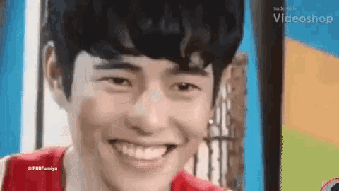a close up of a young man smiling with his mouth open .