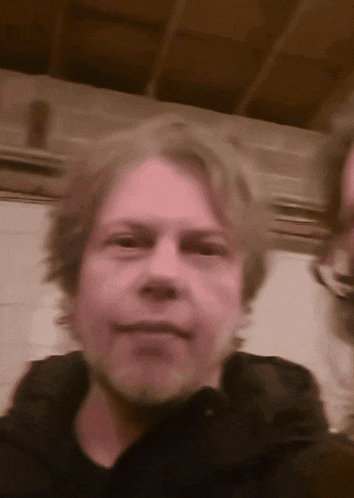 a blurry picture of a man 's face with a purple background