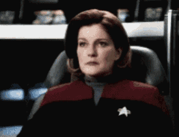 a woman sitting in a chair with a star on her collar