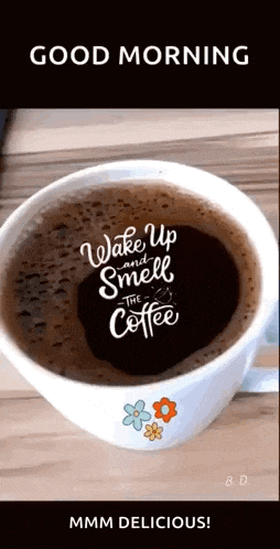 a cup of coffee with the words `` wake up and smell the coffee '' on it is on a table .