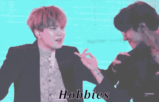 a couple of men are standing next to each other and the word hobbies is on the bottom of the screen