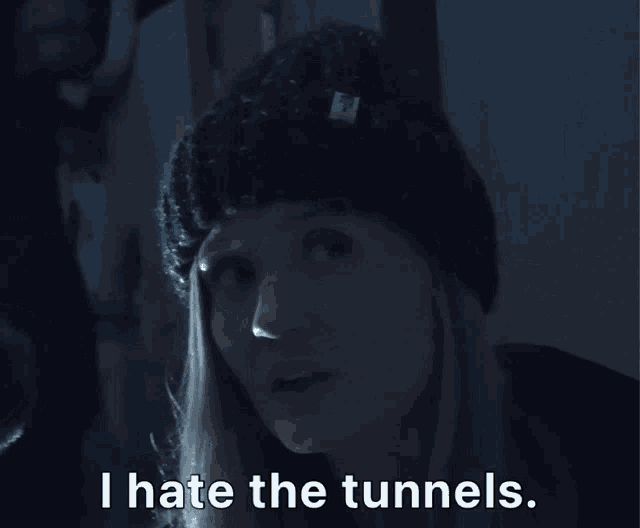 a woman wearing a black beanie says i hate the tunnels