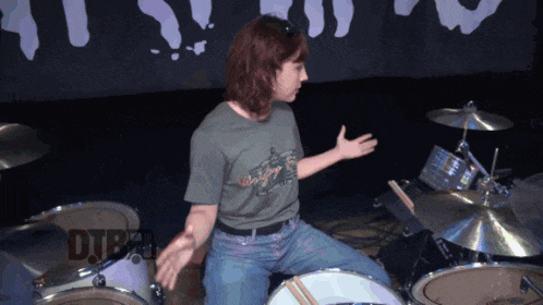 a person playing a drum set with the word dtb on the bottom
