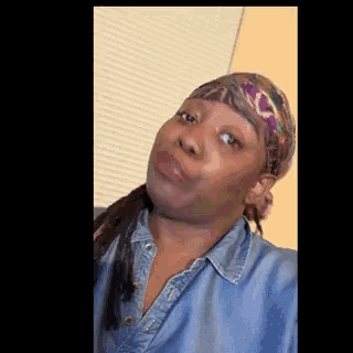 a woman wearing a head scarf and a blue shirt