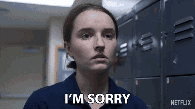 a girl in a blue shirt says i 'm sorry