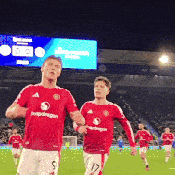two soccer players wearing red jerseys with snapdragon on the front