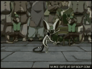a group of monkeys are dancing together in front of a crowd of people .