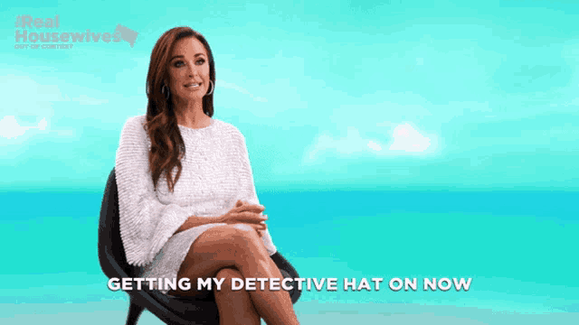 a woman is sitting in a chair with the words getting my detective hat on now