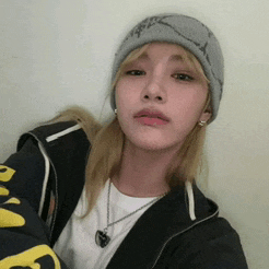 a woman wearing a beanie and a black jacket