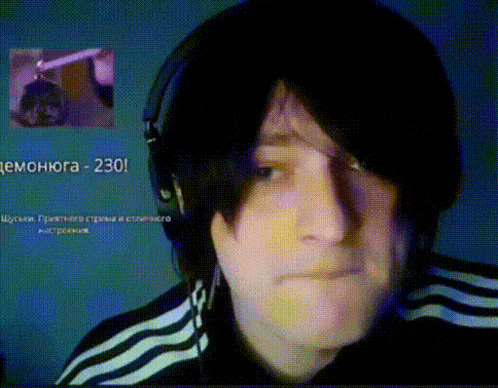 a man wearing headphones looks at the camera with the number 230 in the corner