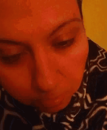 a close up of a woman 's face with a serious look on her face .