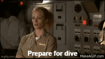 a woman in a military uniform says " prepare for dive " in front of a control panel