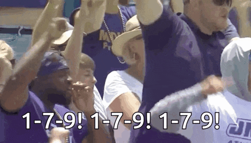 a group of people are raising their arms in the air with the words 1-7-9 on the bottom