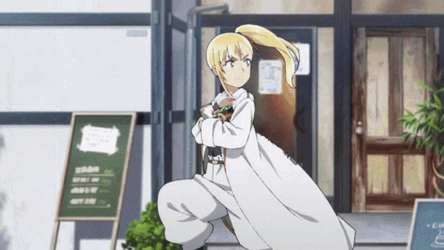 a girl in a white coat is squatting down in front of a restaurant