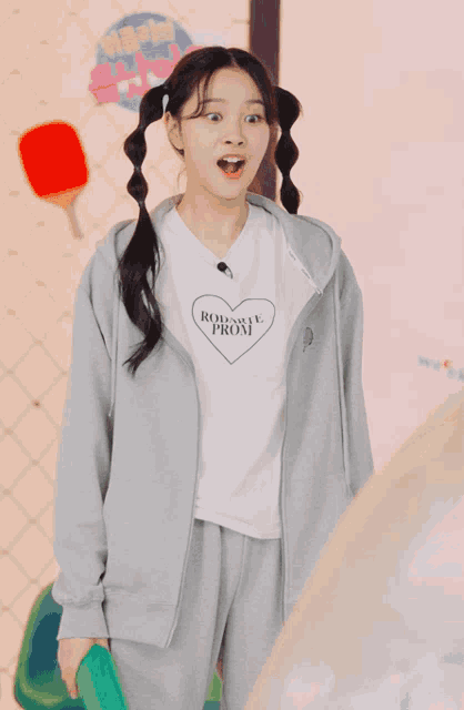 a girl wearing a hoodie and a white t-shirt that says romance from