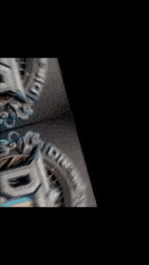 a blurred image of a watch face with the letter dt on it