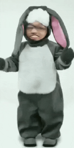 a child dressed in a bunny costume with pink ears