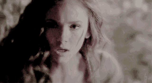 a close up of a woman 's face with a scratch on her face .