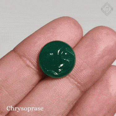 a person holds a green chrysoprase in their hand