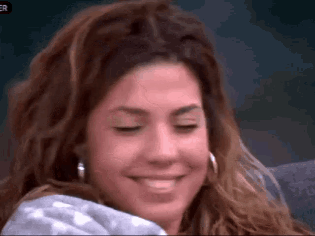 a close up of a woman 's face with the word er on the bottom left
