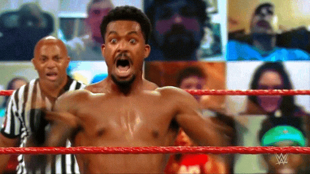 a man without a shirt is standing in a wrestling ring with his mouth open .