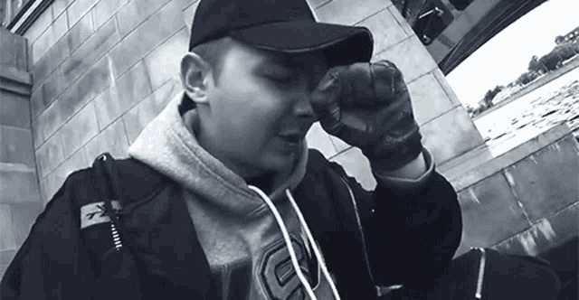 a man wearing a hat and a hoodie with the letter c on it